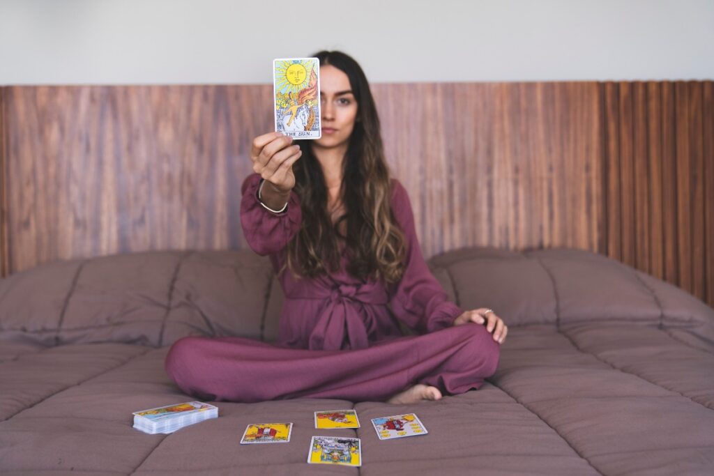 Woman sitting in a quiet peaceful space preparing to do her first tarot card reading.