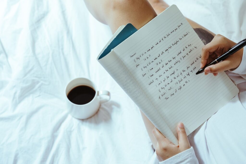 Writing gratitude notes about finances in a journal
