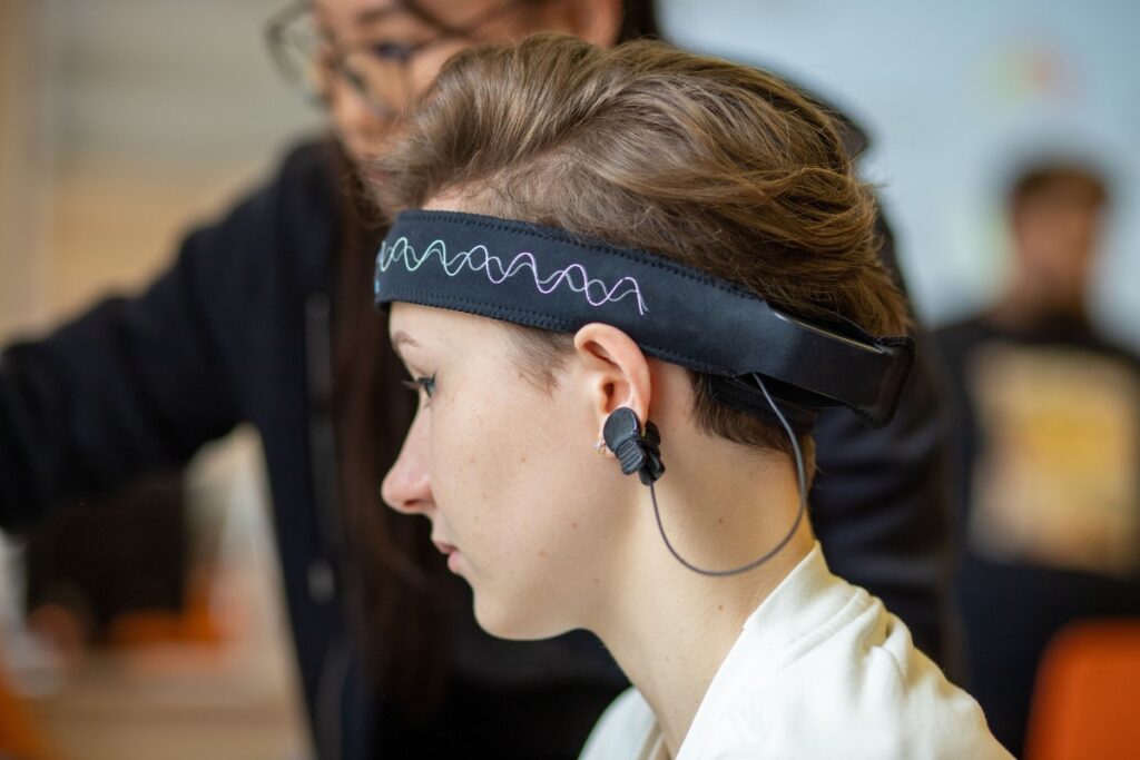 Person wearing an EEG headset during a brain wave frequency test