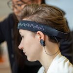 Person wearing an EEG headset during a brain wave frequency test