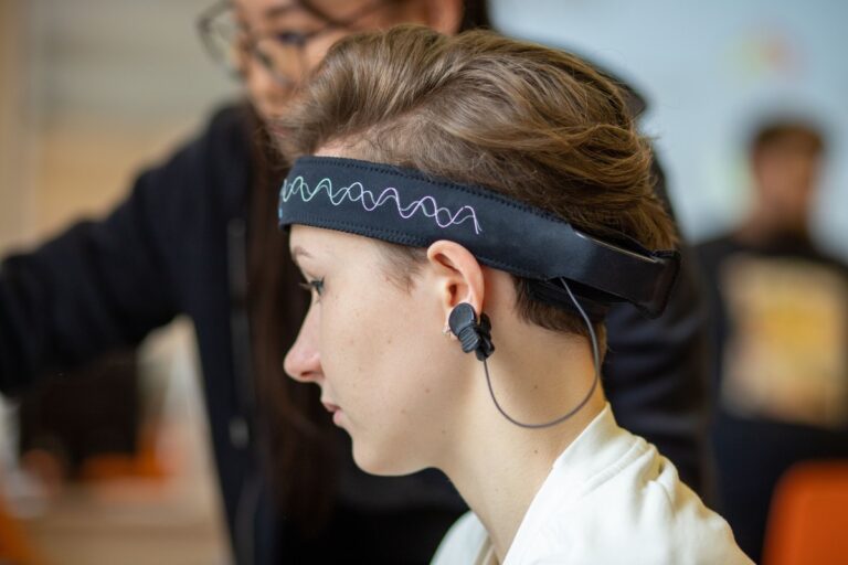 Person wearing an EEG headset during a brain wave frequency test
