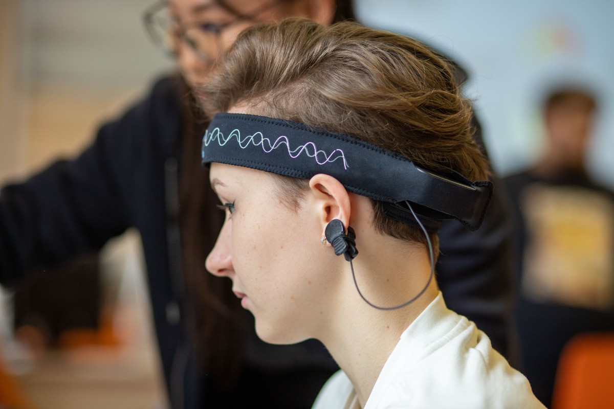 Person wearing an EEG headset during a brain wave frequency test