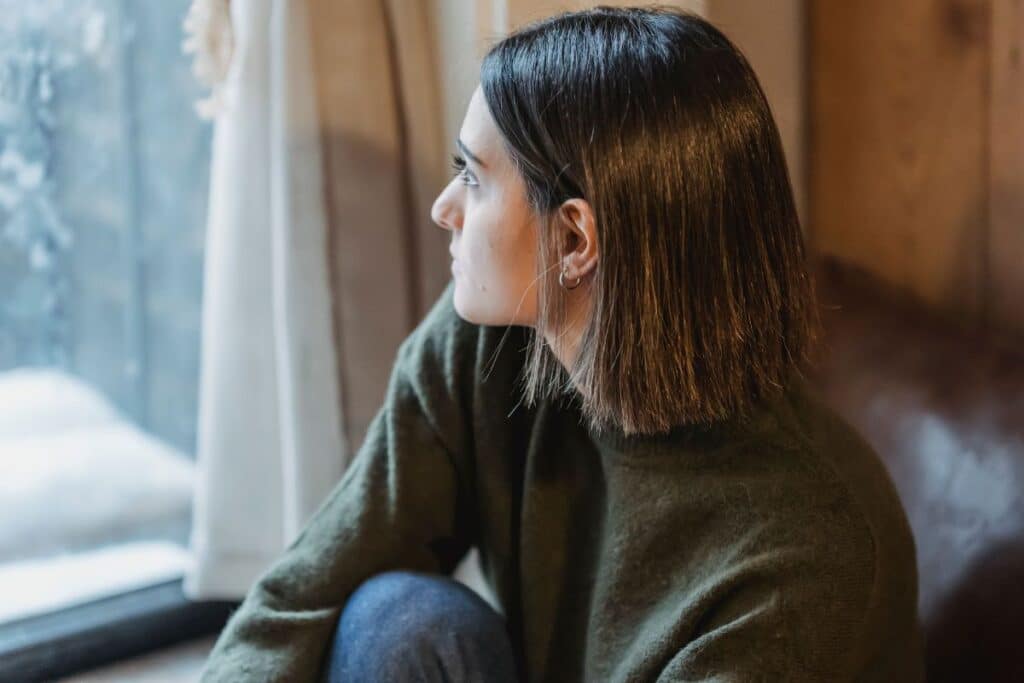 oman calmly daydreaming while staring out