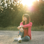 Woman sitting alone smiling peacefully
