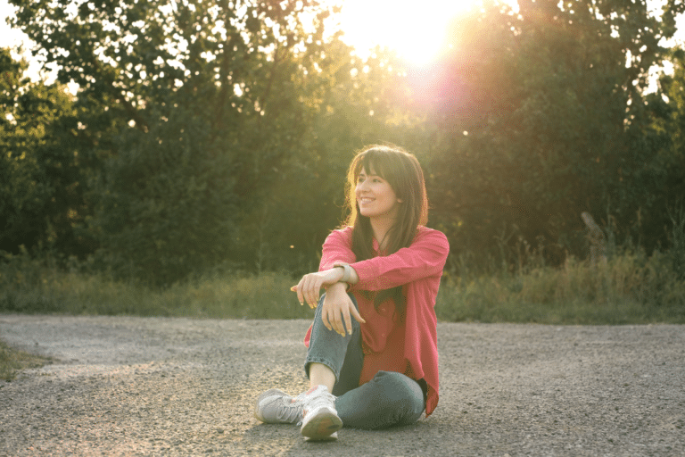 Woman sitting alone smiling peacefully