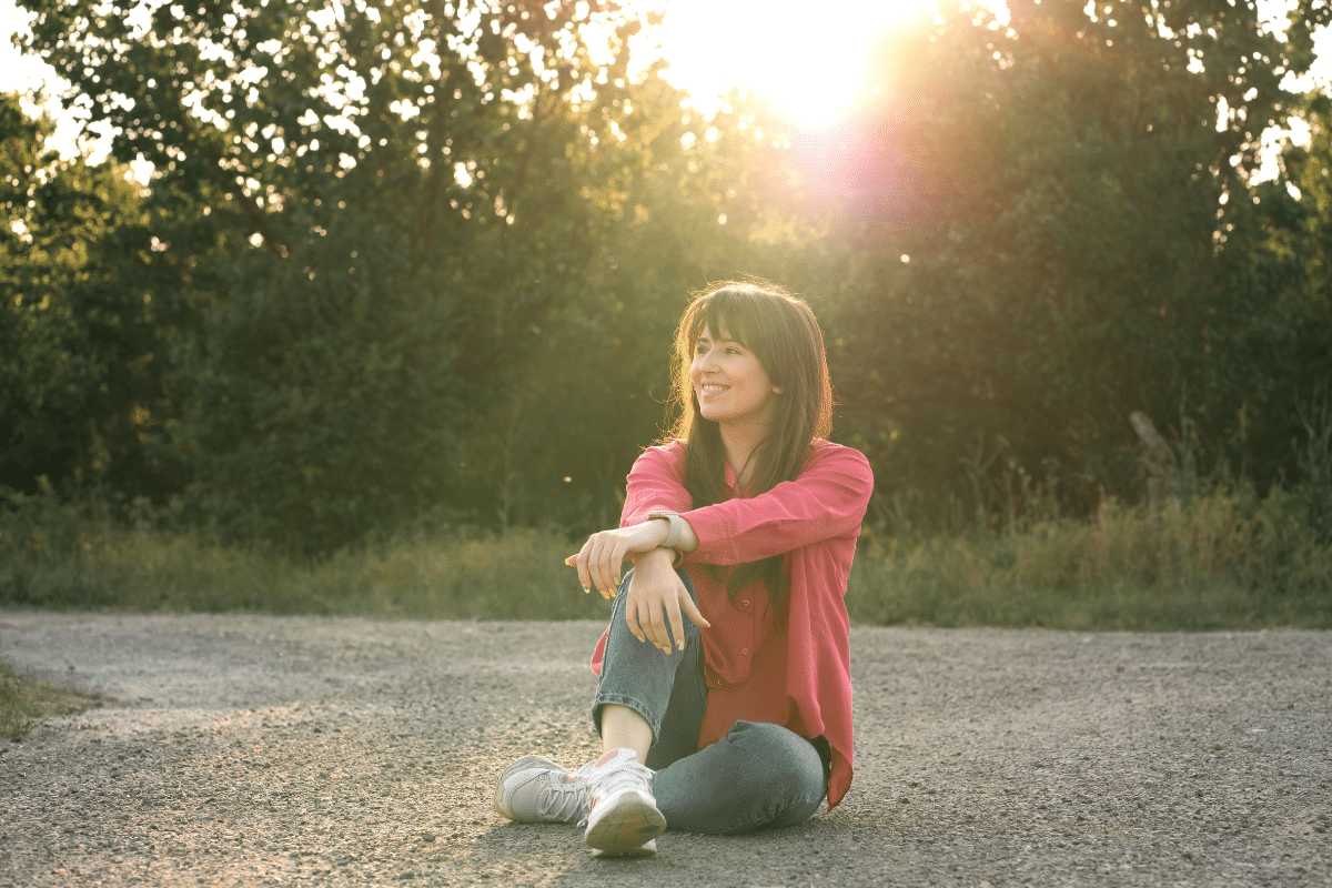 Woman sitting alone smiling peacefully