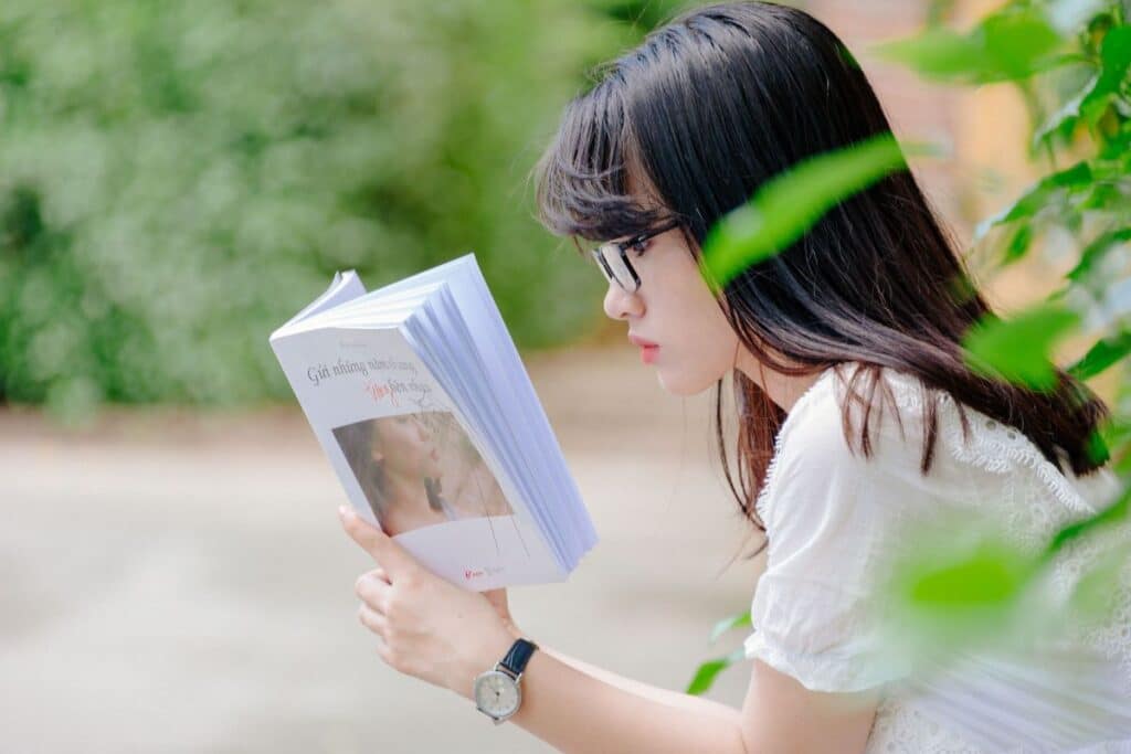 Woman reading affirmations from a book