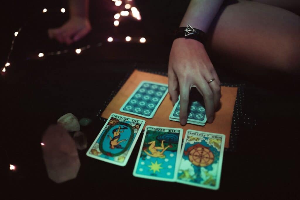 hree tarot cards placed face down in a row representing the past present and future spread positions