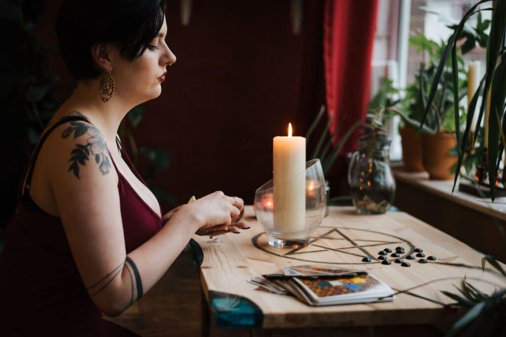 Woman thoughtfully studying three tarot cards together to read them as a single connected story
